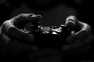 Two hands holding gaming X-Box One controller.